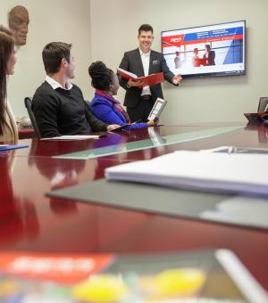 Corporate trainer presenting during a business meeting and professional development session