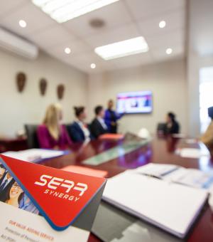 Business training materials and professionals attending a corporate workshop in a modern boardroom