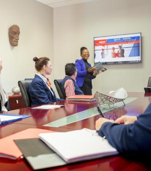 Business consultant presenting to clients during a professional corporate workshop