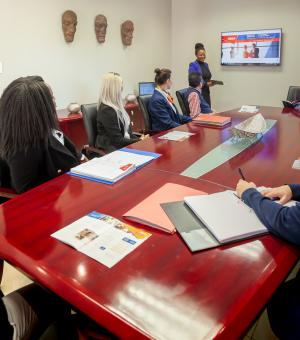 Business professionals attending a corporate meeting and training presentation