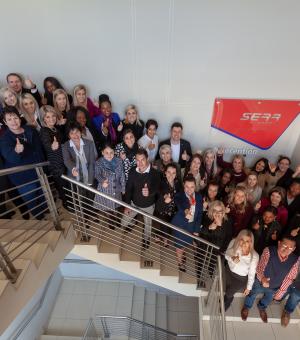 Corporate team celebrating teamwork and business success at the company office