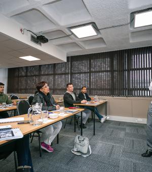 Business trainer presenting ideas on a flip chart during a workplace training session