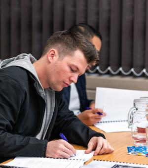 Learner taking notes during a professional training and skills development workshop