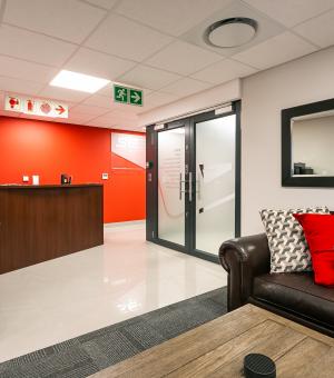 Professional business reception area with modern seating and front desk