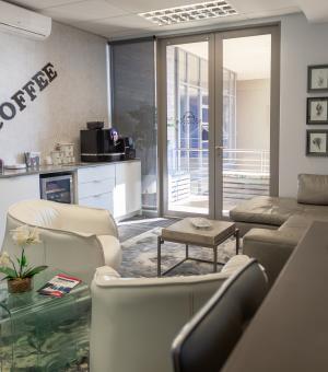 Modern office coffee lounge with comfortable seating and coffee station
